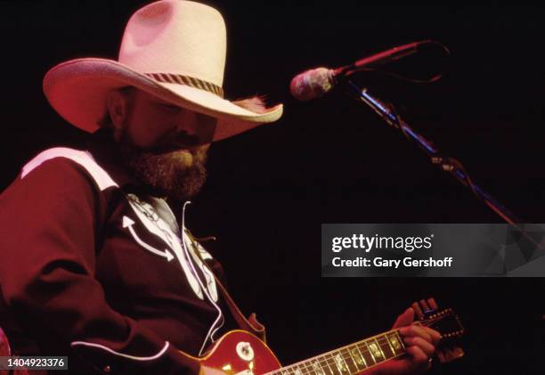 American Country, Rock, and Bluegrass musician Charlie Daniels plays guitar as he performs onstage at Saratoga Springs, Saratoga, New York, September...