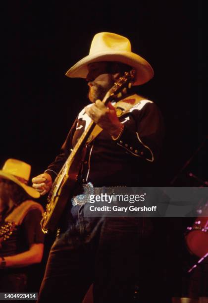 American Country, Rock, and Bluegrass musician Charlie Daniels plays guitar as he performs onstage at Saratoga Springs, Saratoga, New York, September...