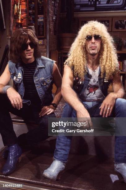 View of American Rock musicians Jay Jay French and Dee Snider, both of the group Twisted Sister, as they sit on a low stage during an interview on...
