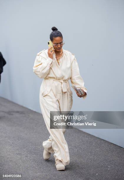 Guest is seen wearing creme white overall outside Dior during Paris Fashion Week - Menswear Spring/Summer 2023 on June 24, 2022 in Paris, France.