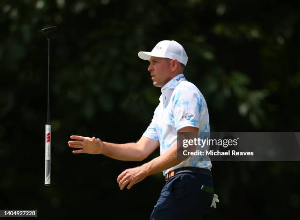 Bo Hoag of the United States tosses his putter on the 11th green during the second round of Travelers Championship at TPC River Highlands on June 24,...