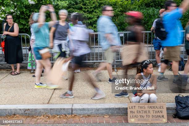 Rachel Nix sits on a curb while processing the Dobbs v Jackson Women's Health Organization ruling in front of the U.S. Supreme Court on June 24, 2022...