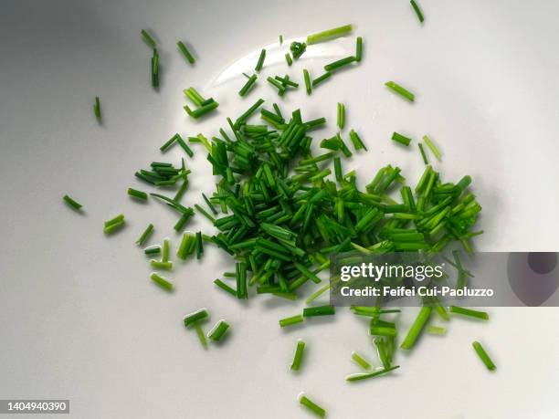 close-up of chopped chives in a white plate - chive stock pictures, royalty-free photos & images