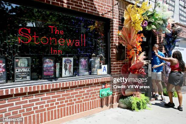 People visit The Stonewall Inn on June 24, 2022 in New York. NYC is getting ready to celebrate his Pride Parade this weekend with multiple activities...