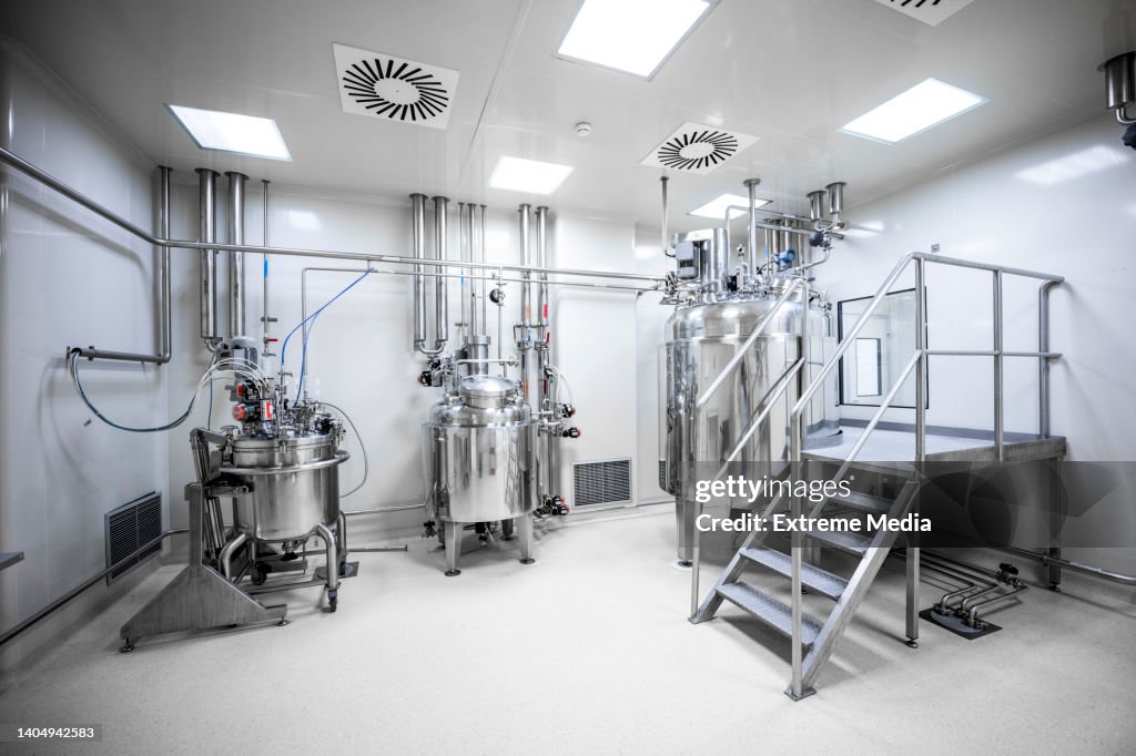 An empty laboratory with three big machines in a pharmaceutical factory