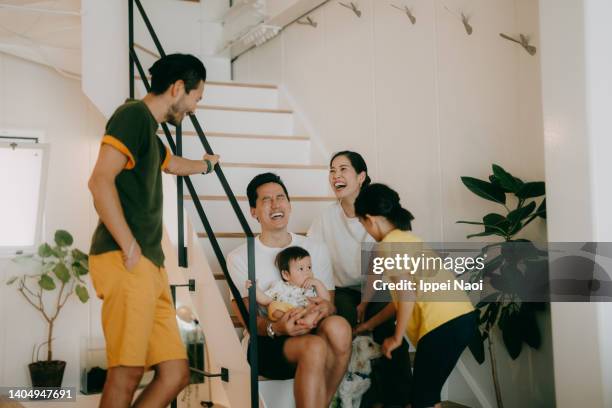 family and friends having a good time at home - eurasian ethnicity stock pictures, royalty-free photos & images