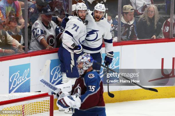 Darcy Kuemper of the Colorado Avalanche looks on as Jan Rutta of the Tampa Bay Lightning celebrates a goal with teammates during the first period in...