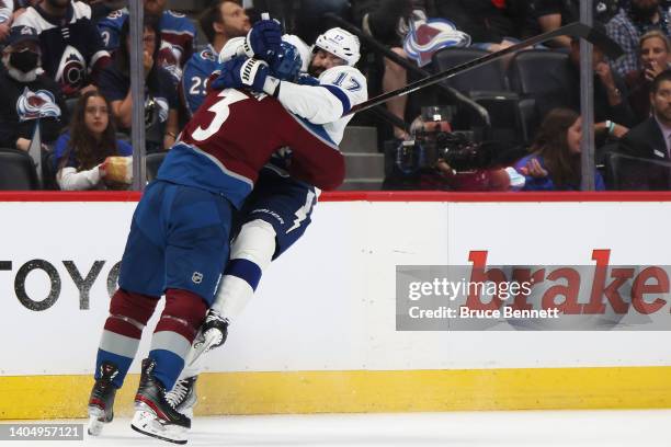 Alex Killorn of the Tampa Bay Lightning is checked by Jack Johnson of the Colorado Avalanche during the first period in Game Five of the 2022 NHL...