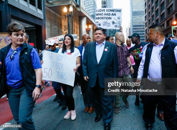 Governor J. B. Pritzker of Illinois marches with protesters during an abortion rights march on June 24, 2022 in Chicago, Illinois. Crowds gathered to...