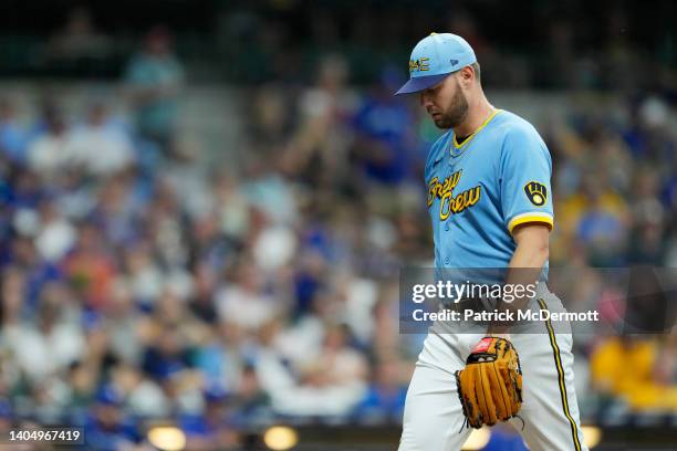 Adrian Houser of the Milwaukee Brewers walks back to the dugout after the top of the fifth inning against the Toronto Blue Jays at American Family...