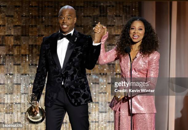 Kevin Frazier and Nischelle Turner accept the Outstanding Entertainment News Series award onstage during the 49th Daytime Emmy Awards at Pasadena...