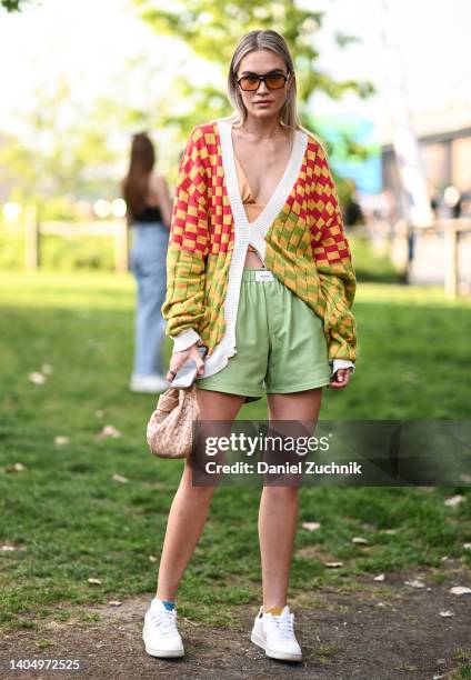 Anastasia Eremenko is seen wearing a plaid AnOnlyChild sweater and green AnOnlyChild shorts with a tan Bottega Veneta bag outside of Made NY on June...