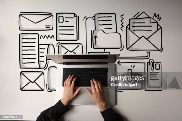 woman using laptop with envelope icons - inbox stockfoto's en -beelden