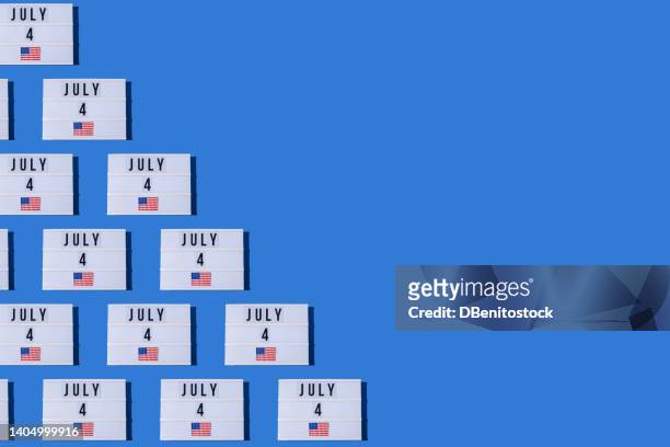 lightbox pattern with the letters 'july 4' and the flag of the united states of america, on the left, on a blue background. concept of patriotism, pride, 4th of july, independence day, celebration - banderola fotografías e imágenes de stock