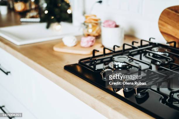 xmas kitchen with fir branches near ingredients for holiday dinner. - stove top stock pictures, royalty-free photos & images