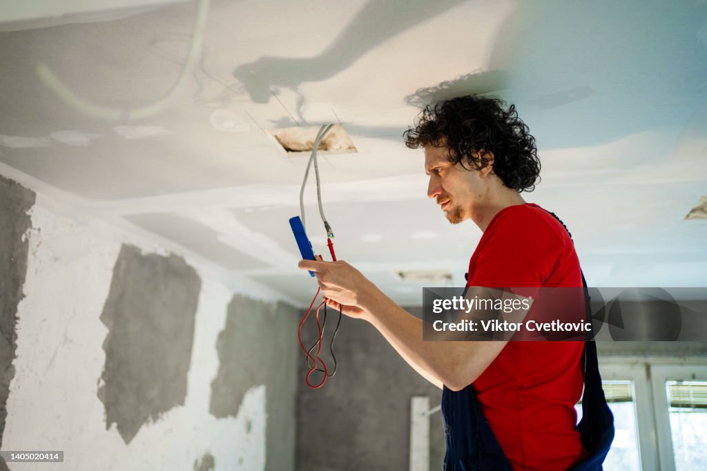 Fixing Wire Problem An Electrician Fixing Wires While Renovating House High-Res Stock Photo ...