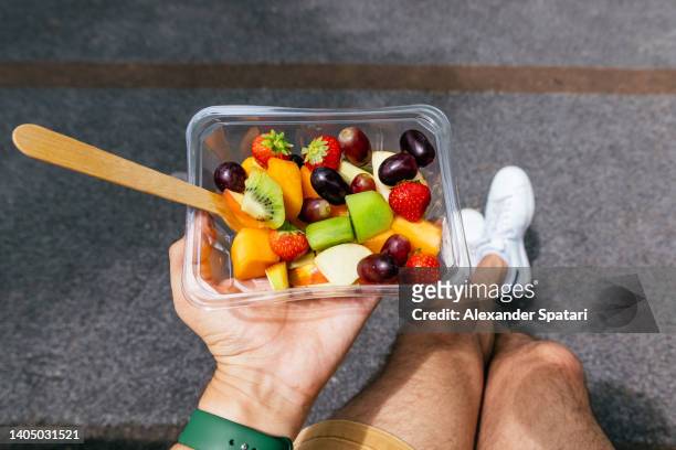 eating fruit salad for lunch outdoors, personal perspective point of view - macedonia fotografías e imágenes de stock