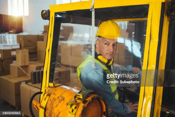 man driving a forklift - boss over shoulder stock pictures, royalty-free photos & images