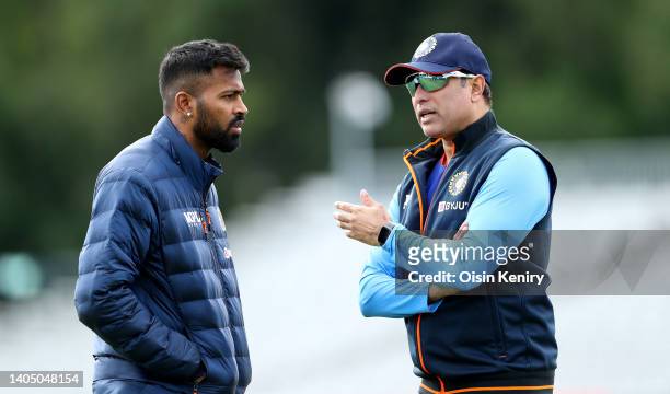 Laxman, Interim head coach of India talks with captain Hardik Pandya during training at Malahide Cricket Club on June 25, 2022 in Dublin, Ireland.