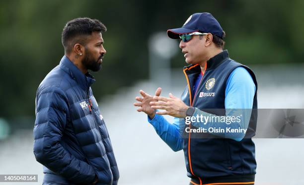 Laxman, Interim head coach of India talks with captain Hardik Pandya during training at Malahide Cricket Club on June 25, 2022 in Dublin, Ireland.