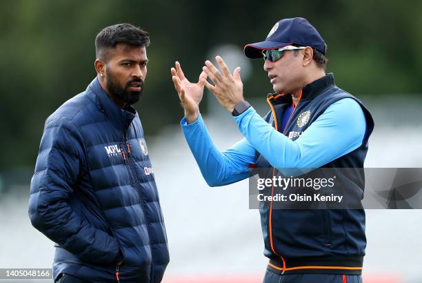 Laxman, Interim head coach of India talks with captain Hardik Pandya during training at Malahide Cricket Club on June 25, 2022 in Dublin, Ireland.