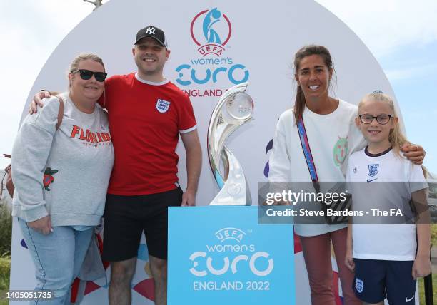 Former England player, Fara Williams poses with Fans and the WEURO 2022 Trophy during the WEURO 2022 Roadshow on Hove Lawns on June 25, 2022 in...