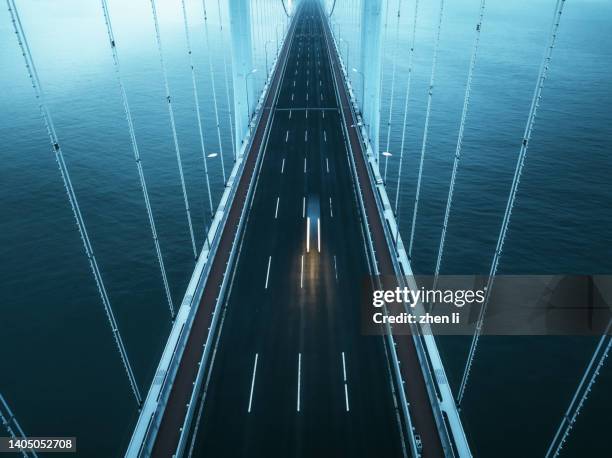 aerial view of cross-sea bridge - ponte sostenuto da cavi foto e immagini stock