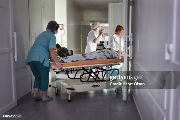 Patient is returned to her room after surgery at the Sloviansk hospital on June 25, 2022 in Sloviansk, Ukraine. The hospital in Sloviansk, a city...