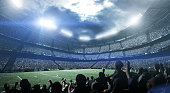 Silhouette of people in the stadium at night.