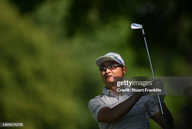 Haotong Li of China plays his approach shot on the 14th hole during Day Three of the BMW International Open at Golfclub Munchen Eichenried on June...