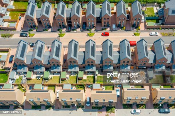 drone view of a new housing development with solar panels - sustainable living - housing development plans stock pictures, royalty-free photos & images