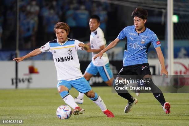 Shota Kaneko of Jubilo Iwata in action under pressure from Tatsuki Seko of Kawasaki Frontale compete for the ball during the J.LEAGUE Meiji Yasuda J1...