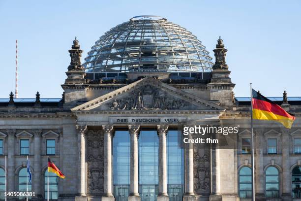 reichstag building with german flags (deutscher bundestag, berlin/ germany) - the reichstag stock pictures, royalty-free photos & images