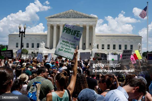 Abortion rights and anti abortion rightactivists fill the street in front of the U.S. Supreme Court during a protest in the wake of the decision...