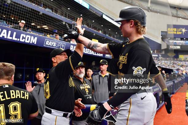 Jack Suwinski of the Pittsburgh Pirates high fives hitting coach Andy Haines after hitting a three run home run in the sixth inning against the Tampa...