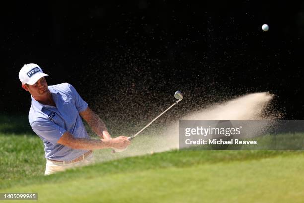 Harris English of the United States plays a shot from a bunker on the tenth hole during the third round of Travelers Championship at TPC River...
