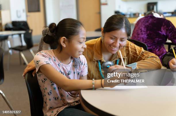 teacher helping a student in a one to one - junior high student stock pictures, royalty-free photos & images