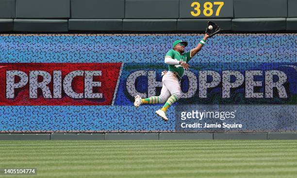 Tony Kemp of the Oakland Athletics makes a diving catch off the bat of MJ Melendez of the Kansas City Royals during the 1st inning of the game at...