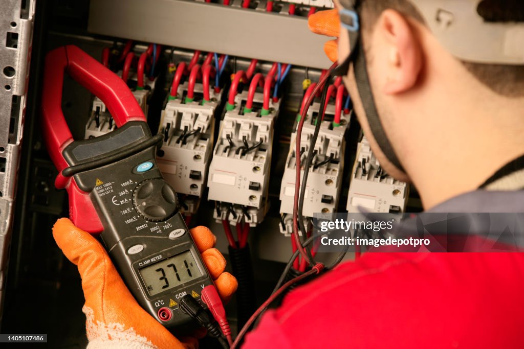 Electrician working on electric panel