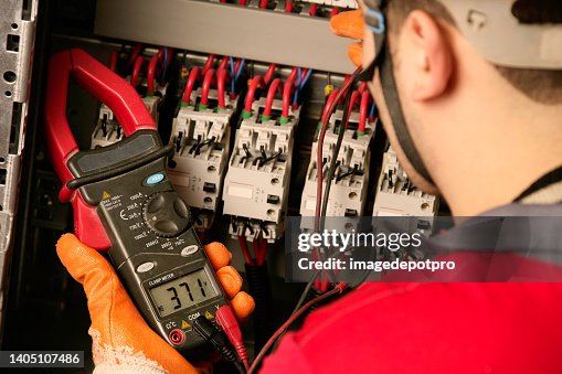 Electrician working on electric panel Electrician working on electric panel