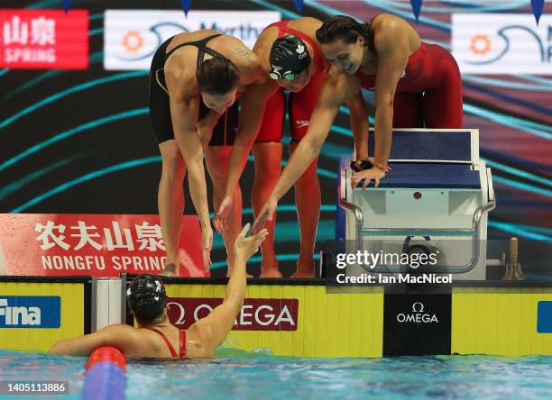 Kylie Masse, Rachel Nicol, Margaret MacNeil are seen on the pool deck after Penny Oleksiak of Team Canada brings them home for bronze during the...