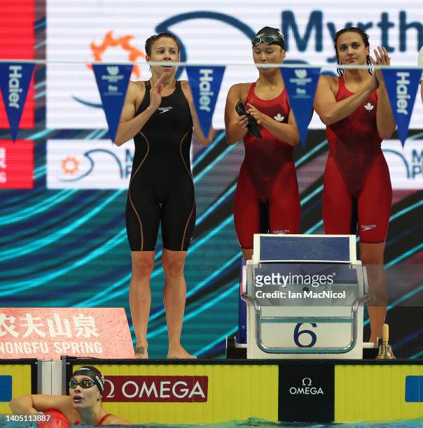 Kylie Masse, Rachel Nicol, Margaret MacNeil are seen on the pool deck after Penny Oleksiak of Team Canada brings them home for bronze during the...