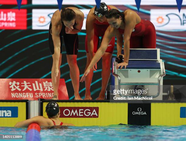 Kylie Masse, Rachel Nicol, Margaret MacNeil are seen on the pool deck after Penny Oleksiak of Team Canada brings them home for bronze during the...