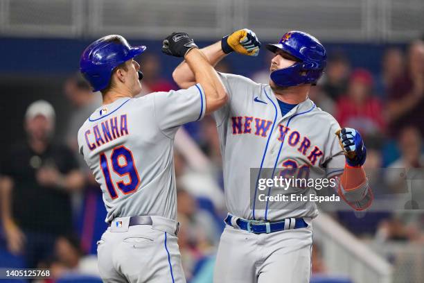 Pete Alonso of the New York Mets celebrates with Mark Canha after hitting a home run in the eighth inning against the Miami Marlins at loanDepot park...