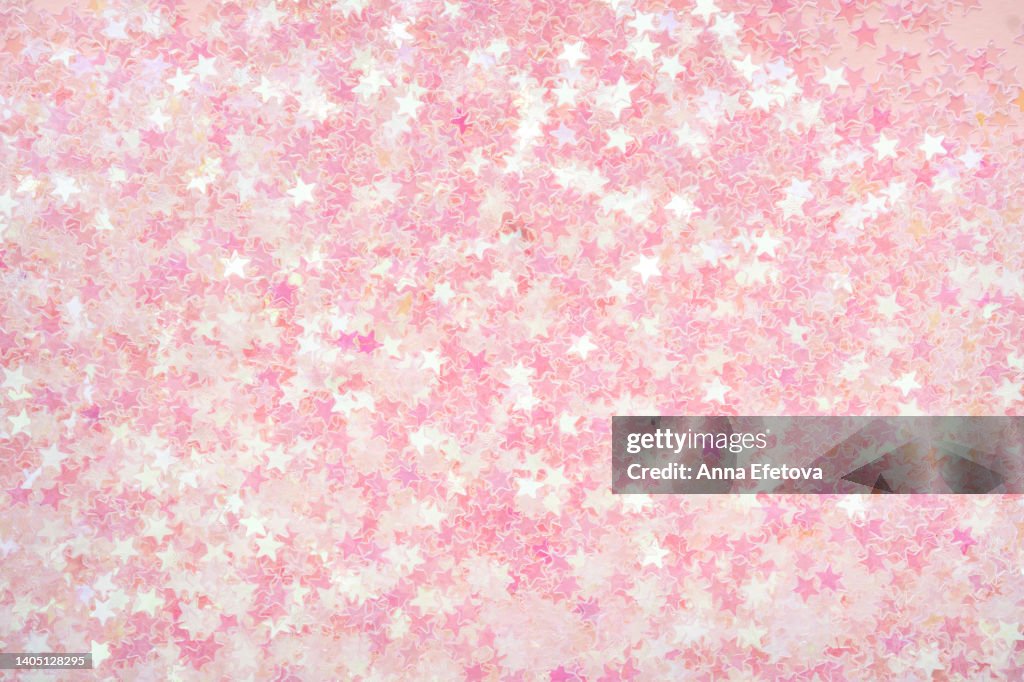 Background made of many small pastel pink stars. Holiday concept. Flat lay style
