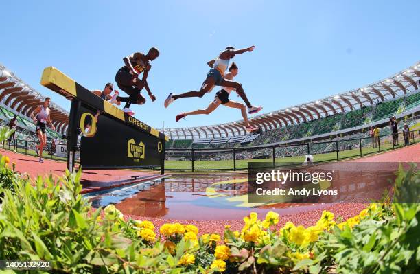 Hillary Bor and Evan Jager clear the water barrier in the Men's 3,000 Meter Steeplechase final during the 2022 USATF Outdoor Championships at Hayward...