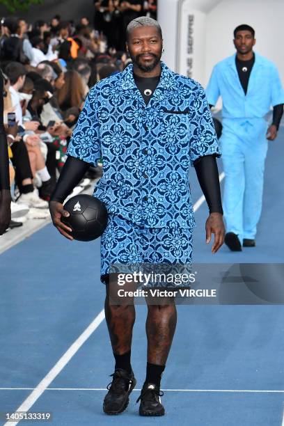 Footbaler Djibril Cissé walks the runway during the Marine Serre Ready to Wear Spring/Summer 2023 fashion show as part of the Paris Men Fashion Week...