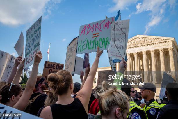 Abortion-rights demonstrators protest in front of the Supreme Court building following the announcement to the Dobbs v Jackson Women's Health...