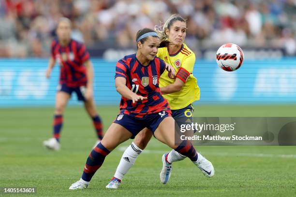 Sophia Smith of Team USA fights for the ball against Daniela Montoya of Colombia in the first half at Dick's Sporting Goods Park on June 25, 2022 in...