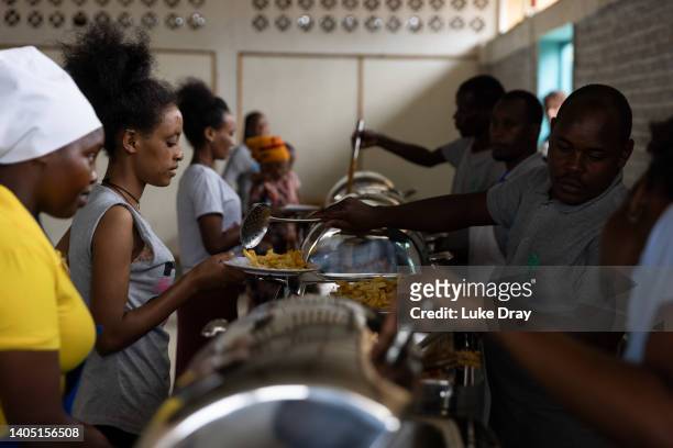 Asylum seekers receive food at a canteen on June 24, 2022 in Gashora, Rwanda. The Gashora Emergency Transit Centre opened in 2019 following an...